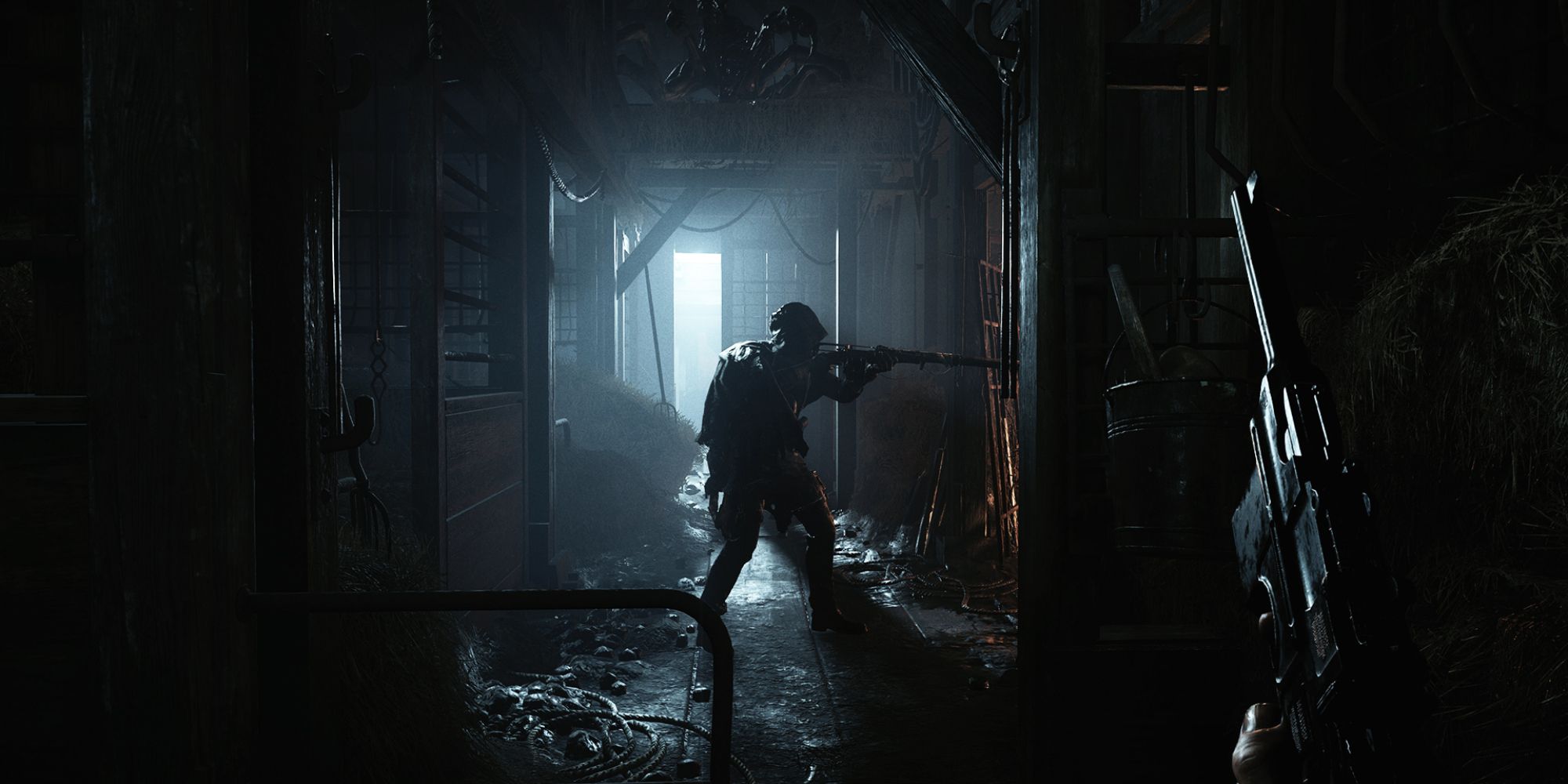 Solo Battle Royales a first-person perspective shot from Hunt: Showdown of a hand holding a pistol looking at a cloaked man in a darkened room holding a rifle