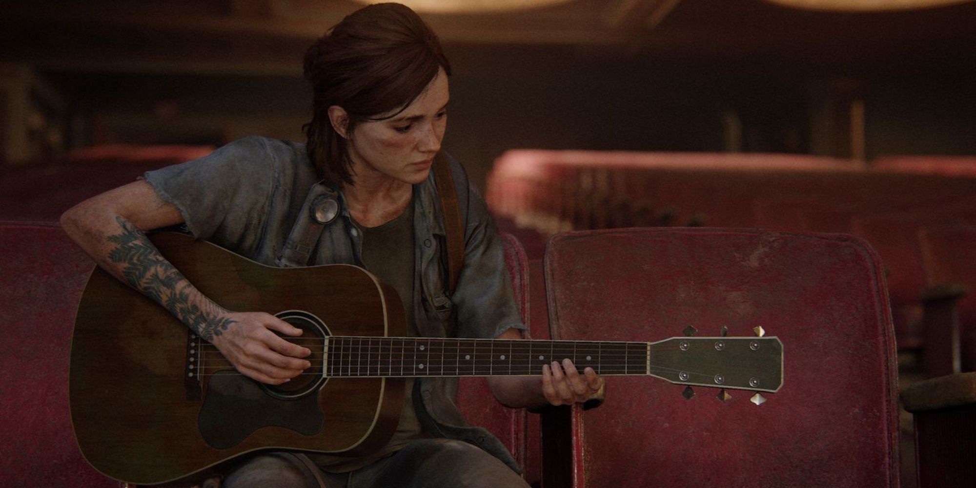 Screenshot from The Last of Us Part 2 showing Ellie playing her guitar