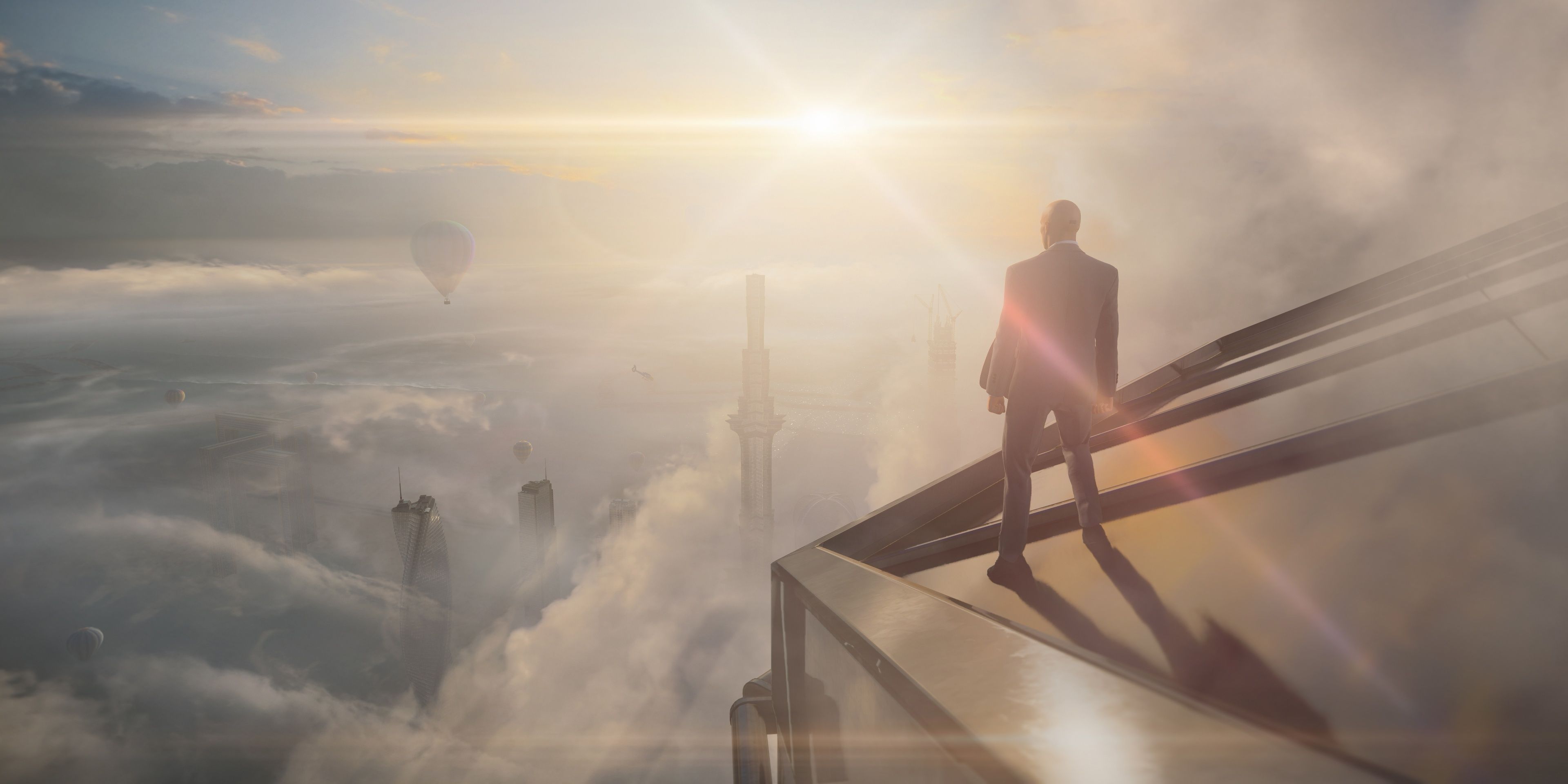 A screenshot showing Agent 47 standing on the edge of a rooftop in Hitman 3