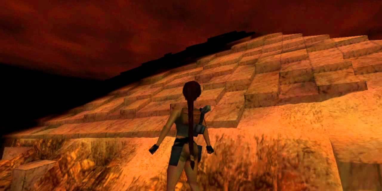 A screenshot showing Lara Croft standing at the base of The Great Pyramid in Tomb Raider: The Last Revelation