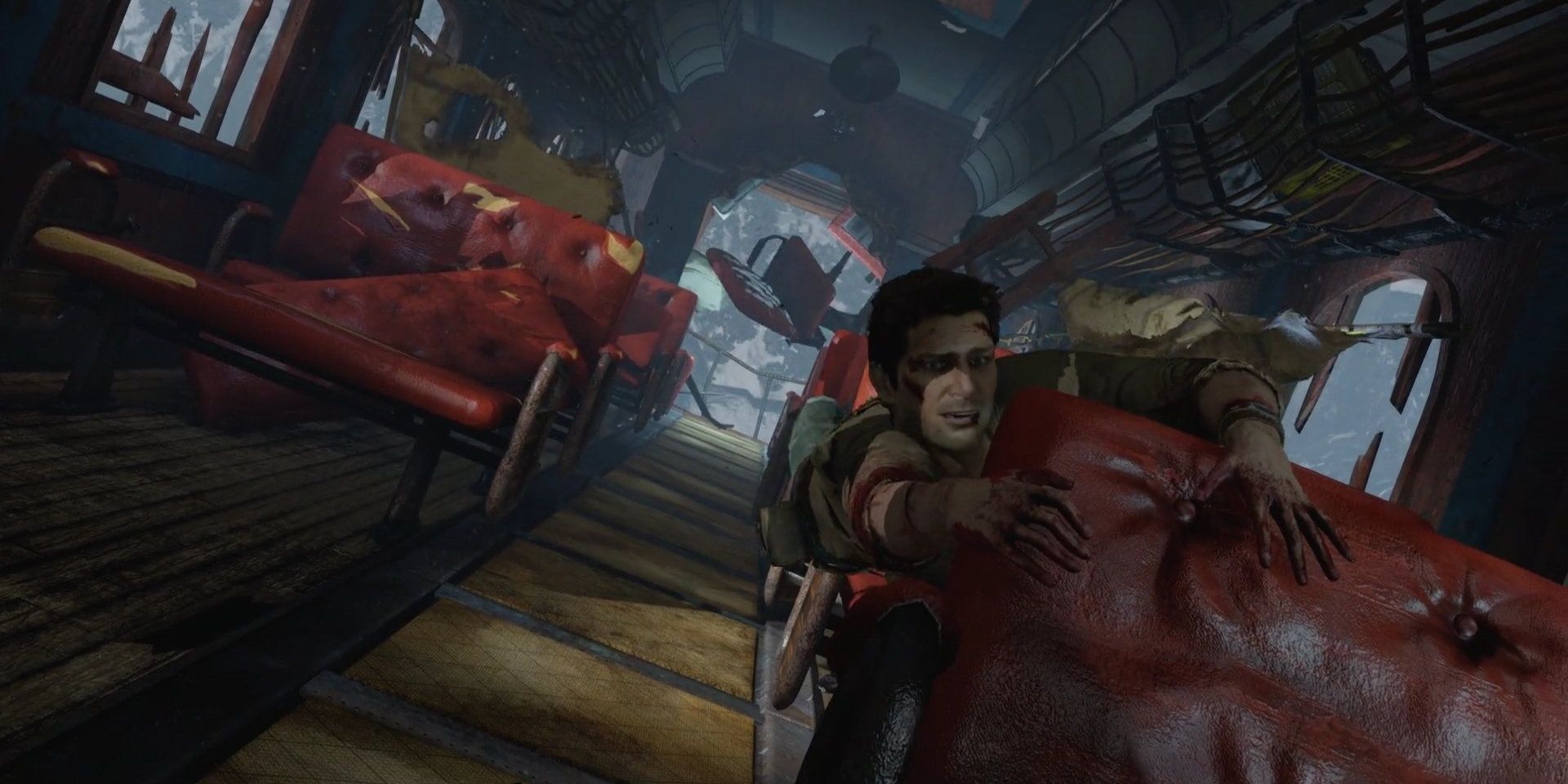 A screenshot showing Nathan hanging inside a wrecked train in Uncharted 2: Among Thieves
