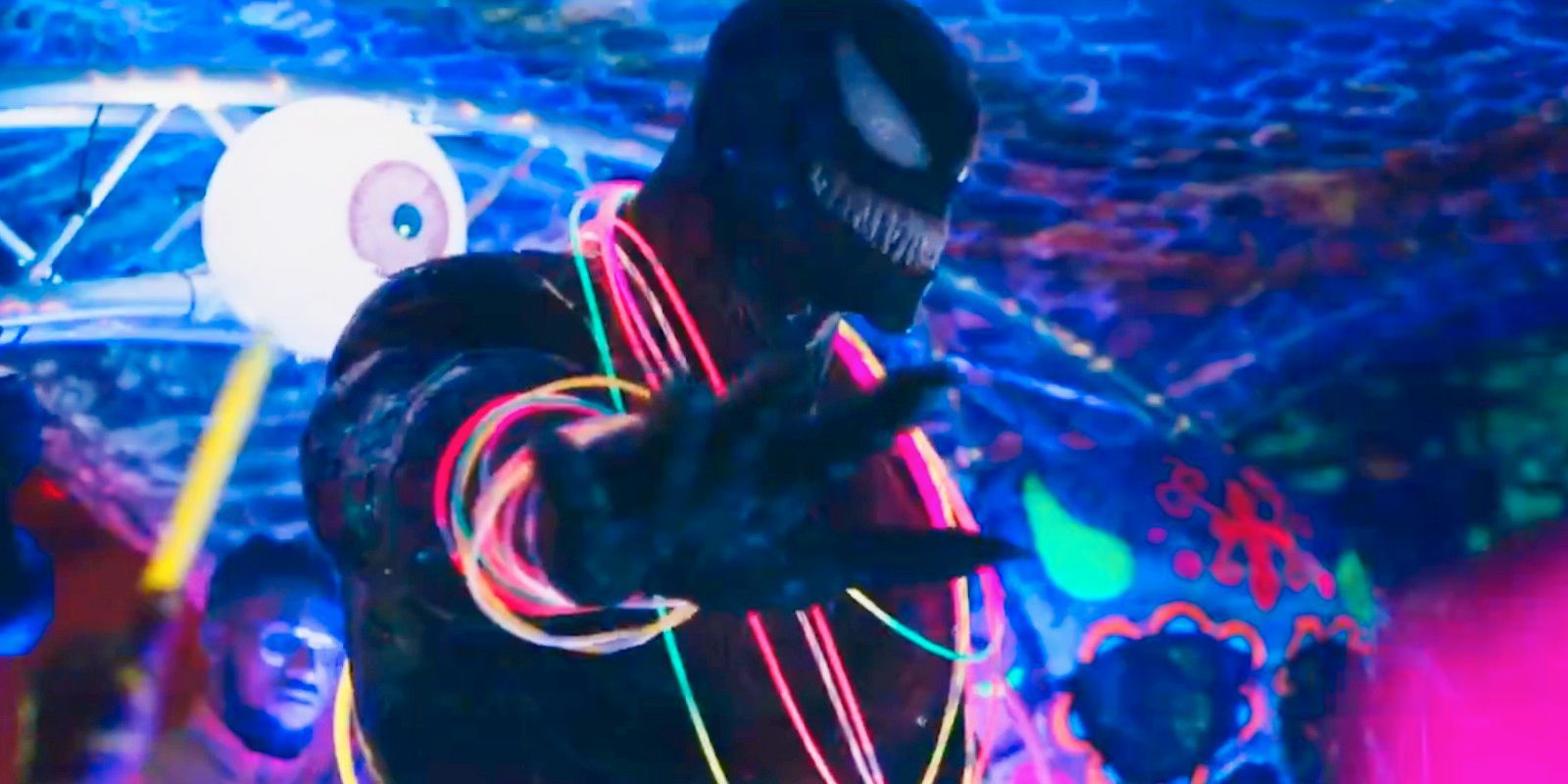 venom with neon bracelts and necklaces in an underground rave