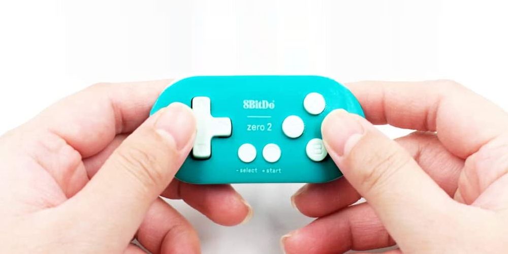 The tiny 8Bitdo Zero 2 in a pair of hands