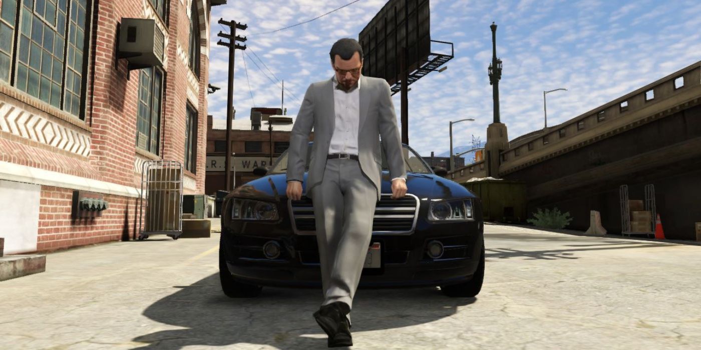 Michael leans against his car and looks down, looking contemplative, in GTA 5