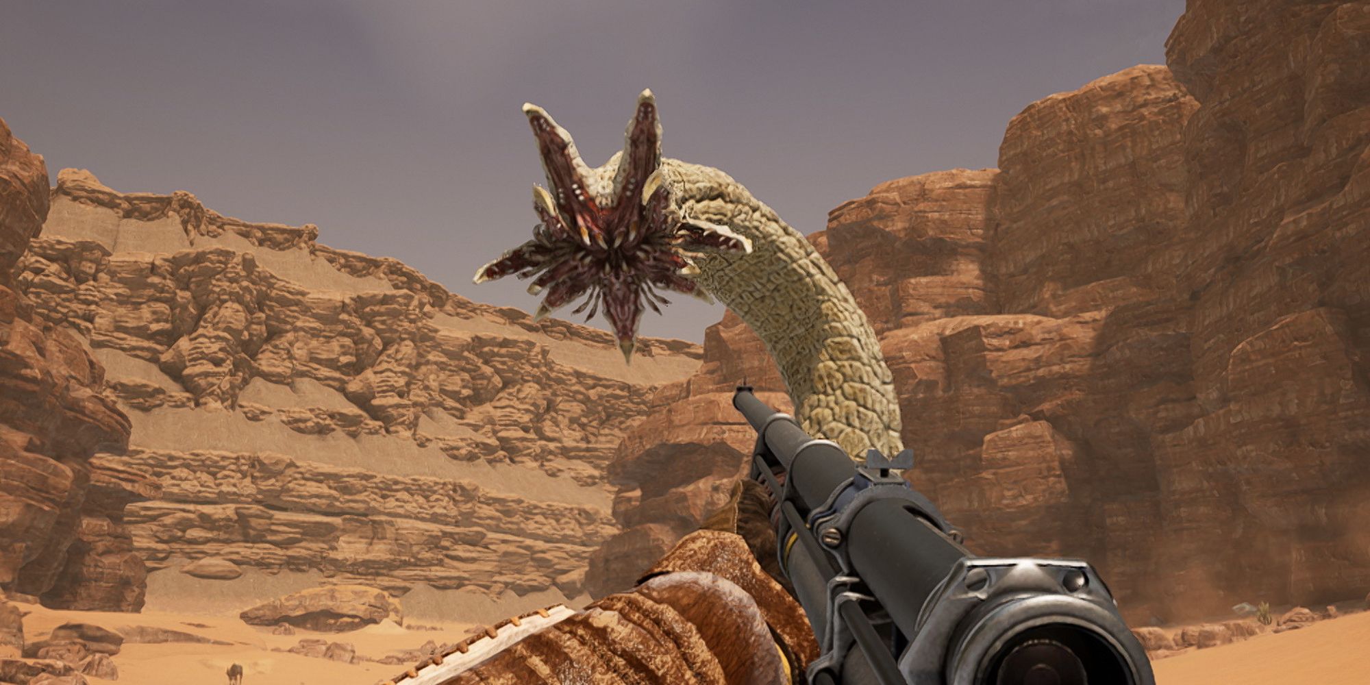 player fighting an alien monster in the desert
