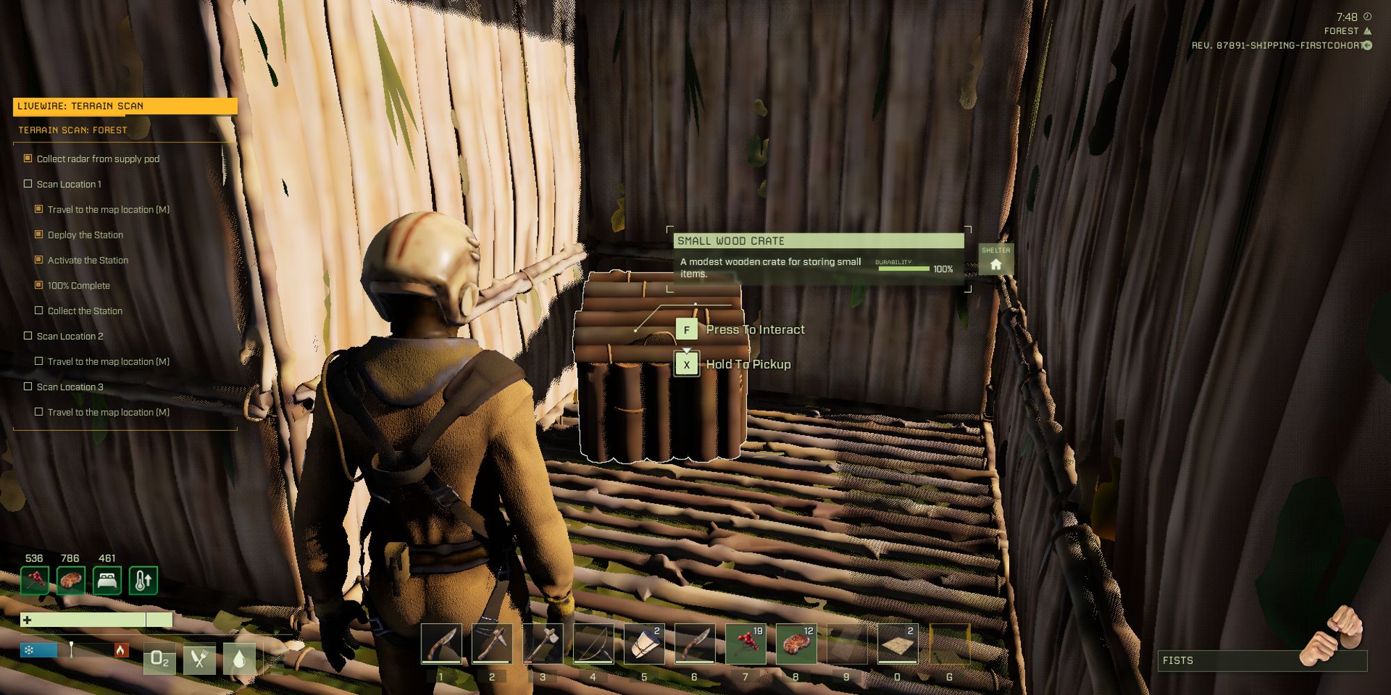 player standing in small hut with wooden chest