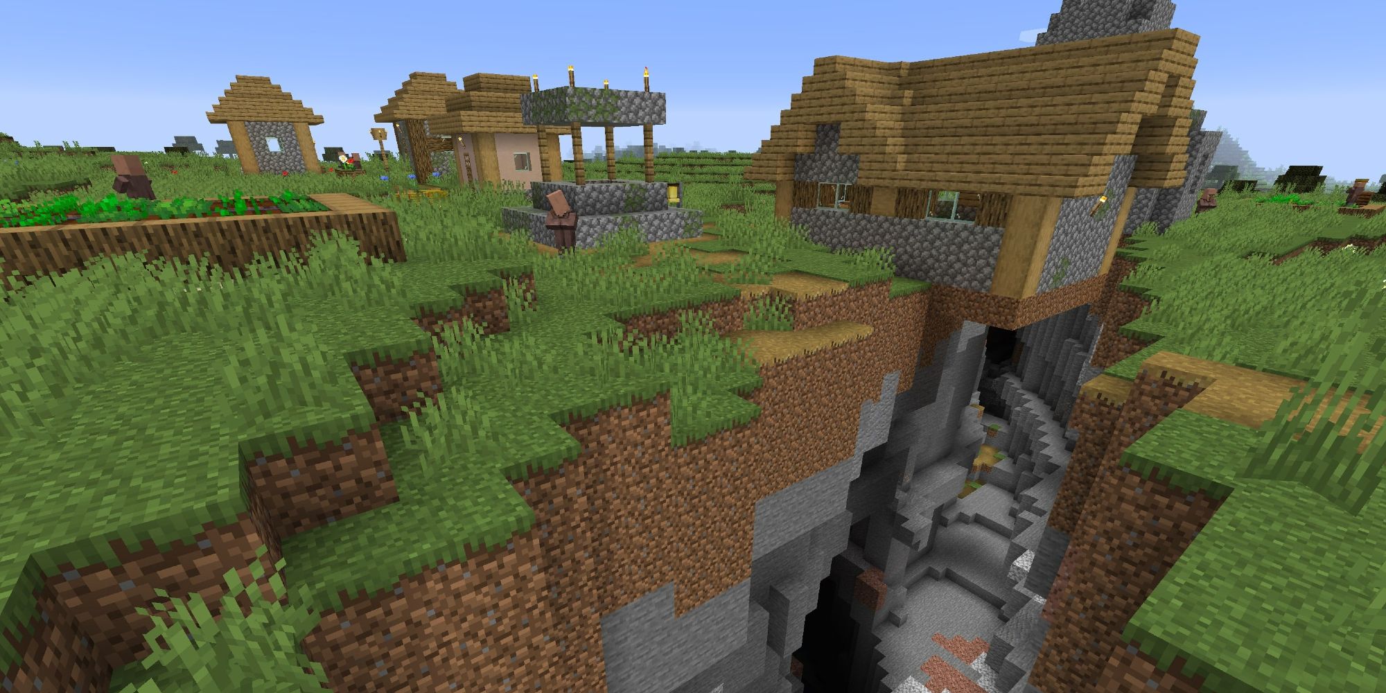 A village right above a ravine in Minecraft