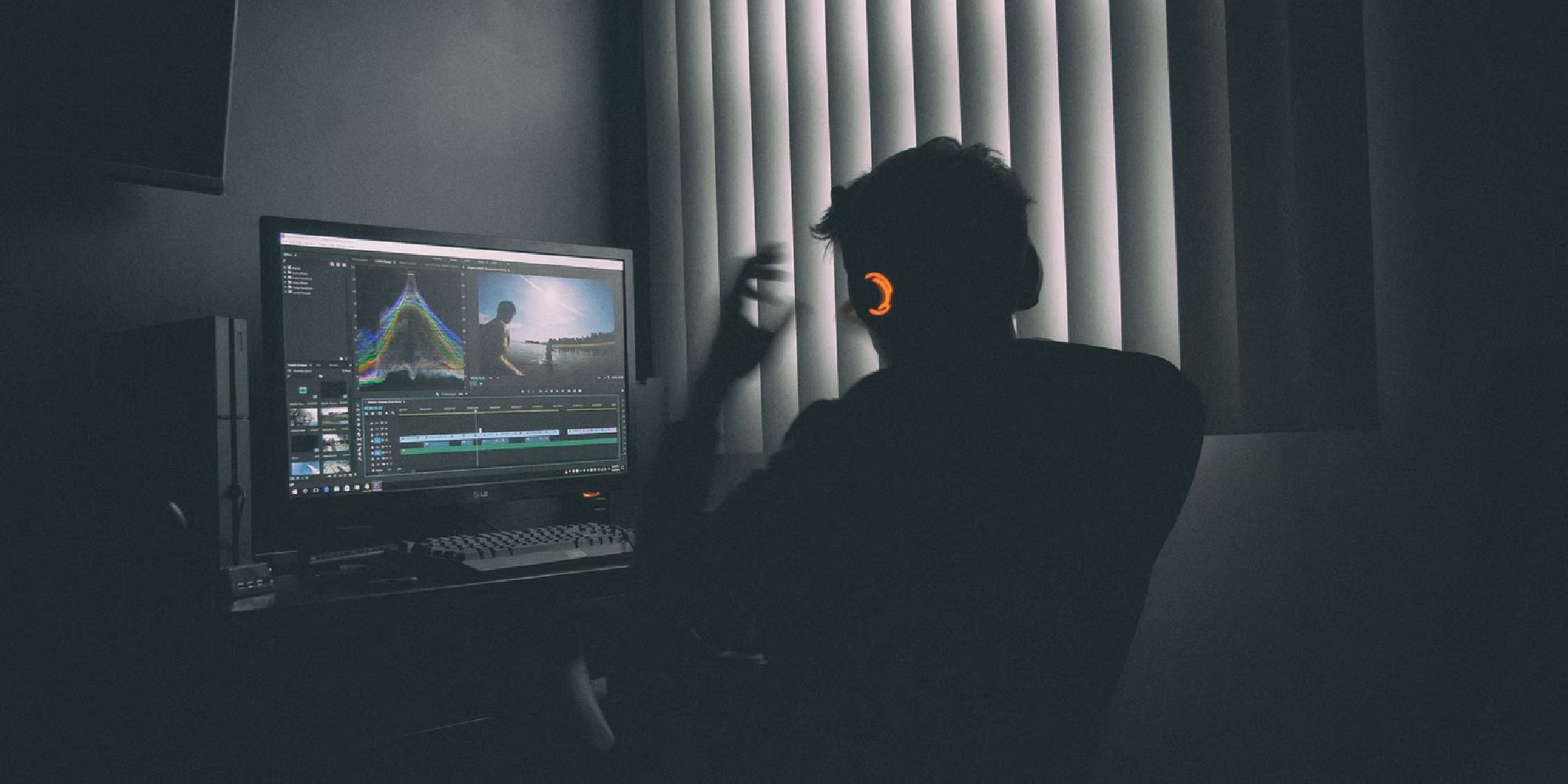 Man taking his headphones off at his desk