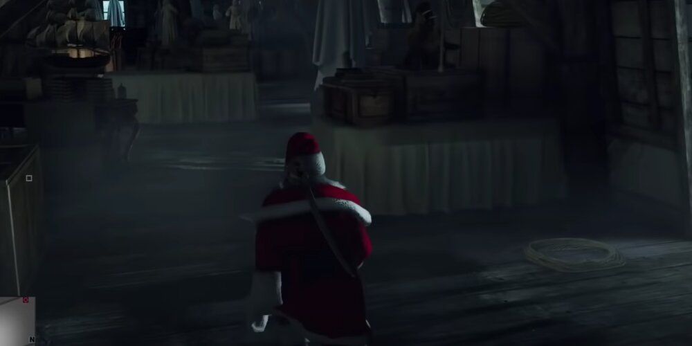 A Screenshot Of Agent 47 In Hitman Dressed As Santa Claus Sneaking Through The Attic In Paris.