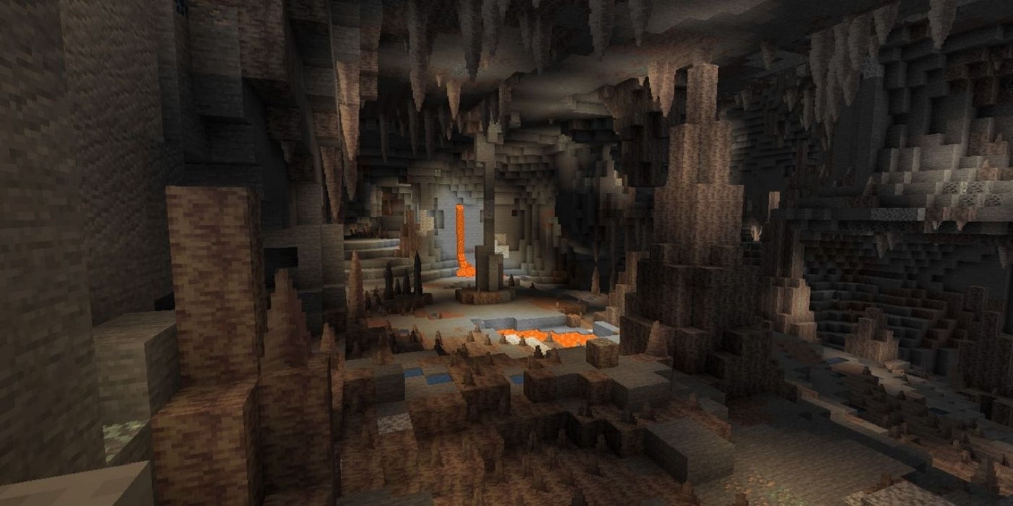 A wide cave with water streams and pools of lava, and dripstone blocks on the ceiling and floor