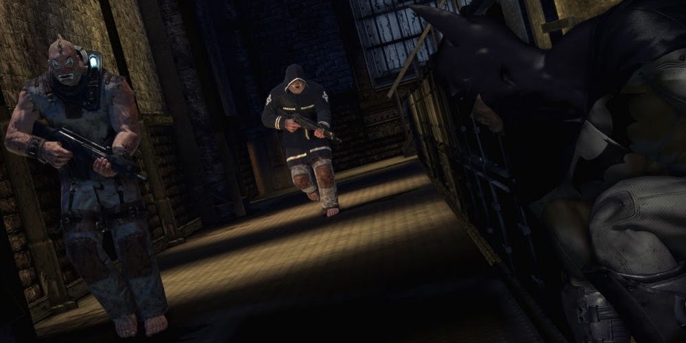 Batman: Arkham Asylum - Batman lurks in the shadows, waiting to pounce on a patrolling goon