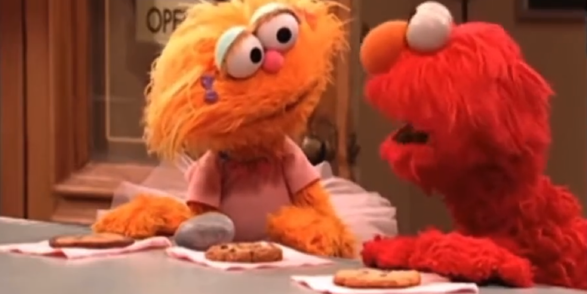 Elmo Zoe Rocco and a cookie