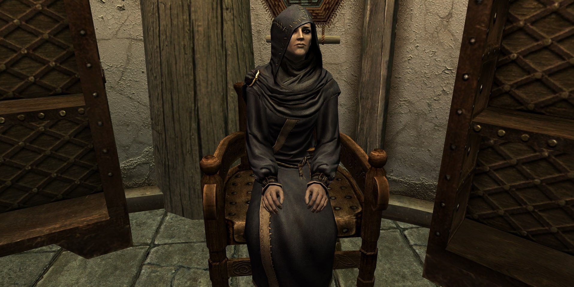 Illia sitting down in a chair in Skyrim.