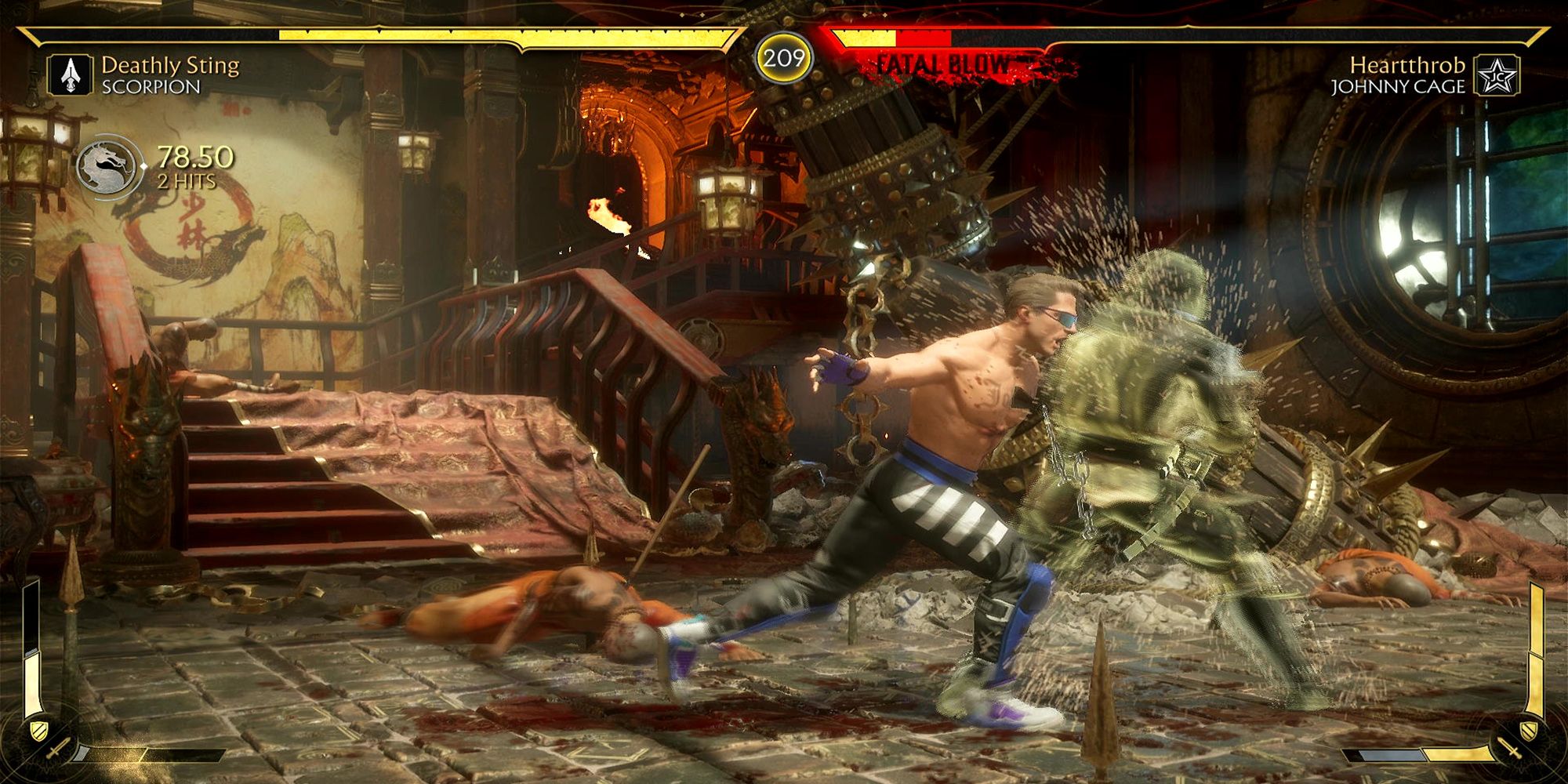 Scorpion unleashes an amplified spear special move on Johnny Cage in the Shaolin Trap Dungeon in Mortal Kombat 11.