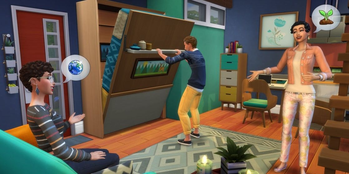 Two Sims chat in the living room of their tiny home, while another tries to pull down their murphy bed