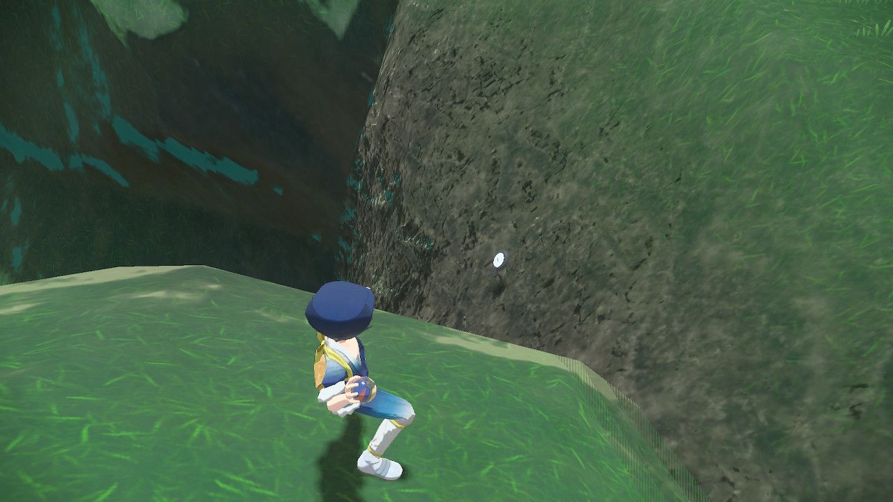 Pokemon Trainer aiming his pokeball at Unown R on a mountain side, in Pokemon Legends Arceus.
