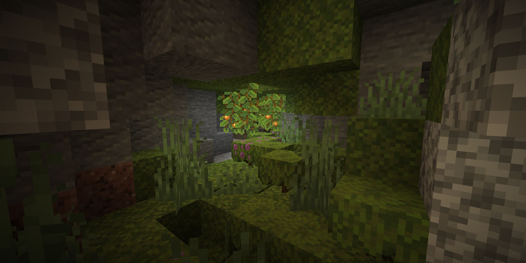 player looking through a small lush cave at azaleas