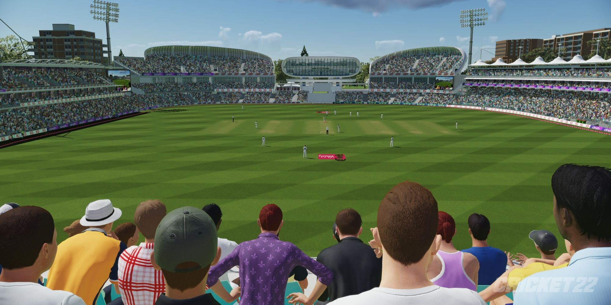 a wide angle shot overlooking a stadium with a cricket match happening in the middle from behind a large crowd of people