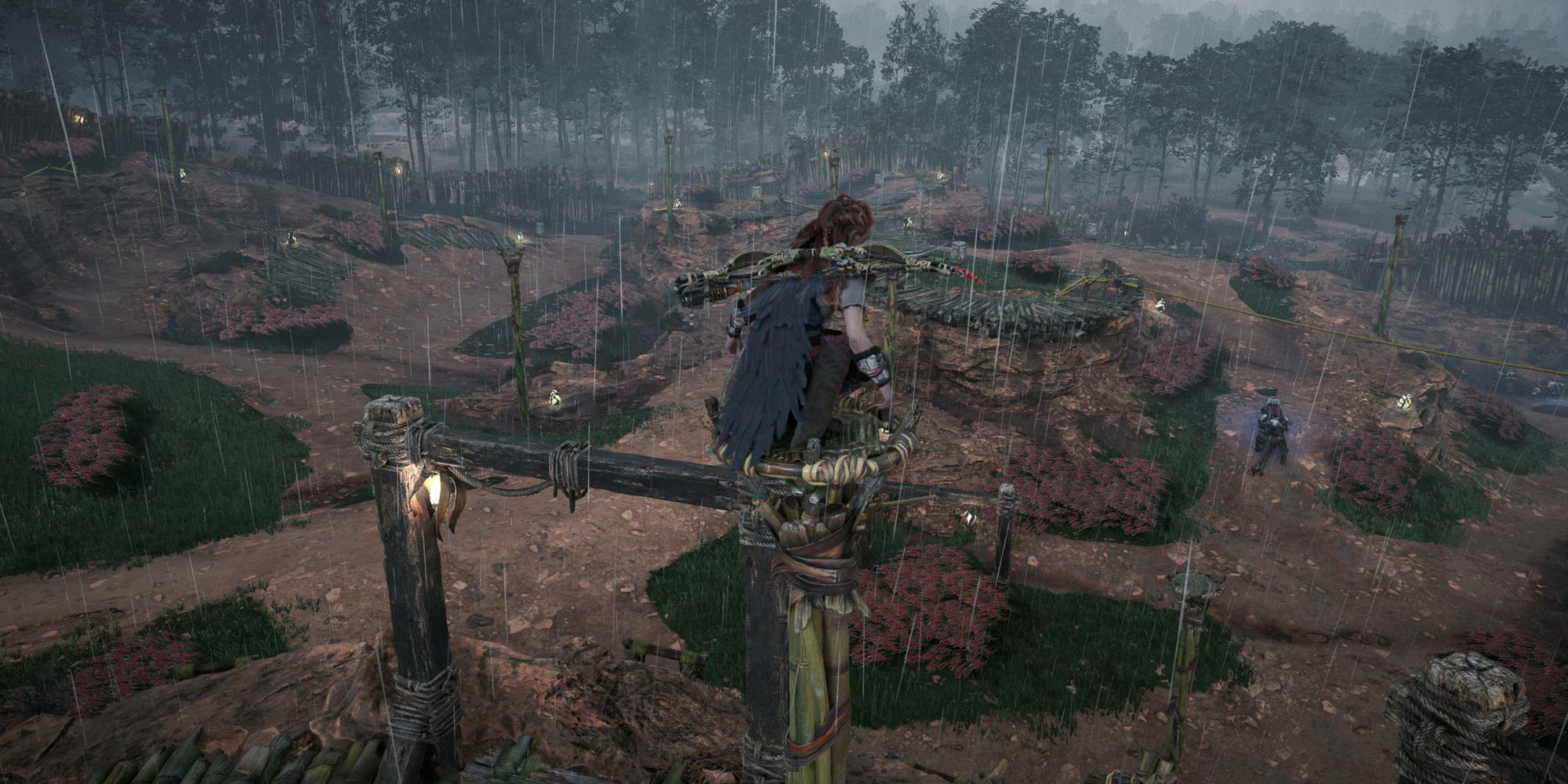 Horizon: Forbidden West Hunting Grounds. Aloy surveying area from atop a structure.