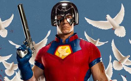 Peacemaker holding his handgun with doves in the background.