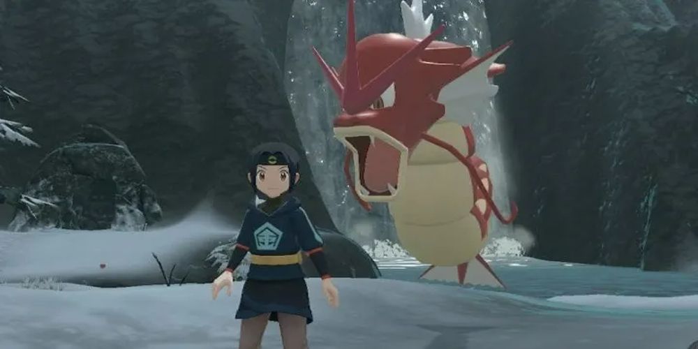 A Shiny Gyarados behind a player in a snowy area in Pokemon Legends Arceus