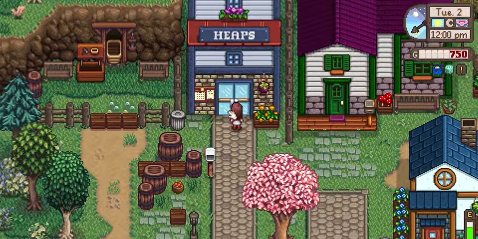 A photo of Heap's Convenience Store in Ridgeside Village (Centered). To the left, a minecart with a special items box beside it. To the right, a residential building.