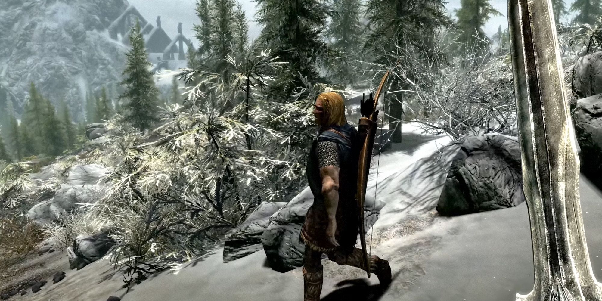 A Skyrim hero who wields a sword while walking through snowy hills. NPC on the right.