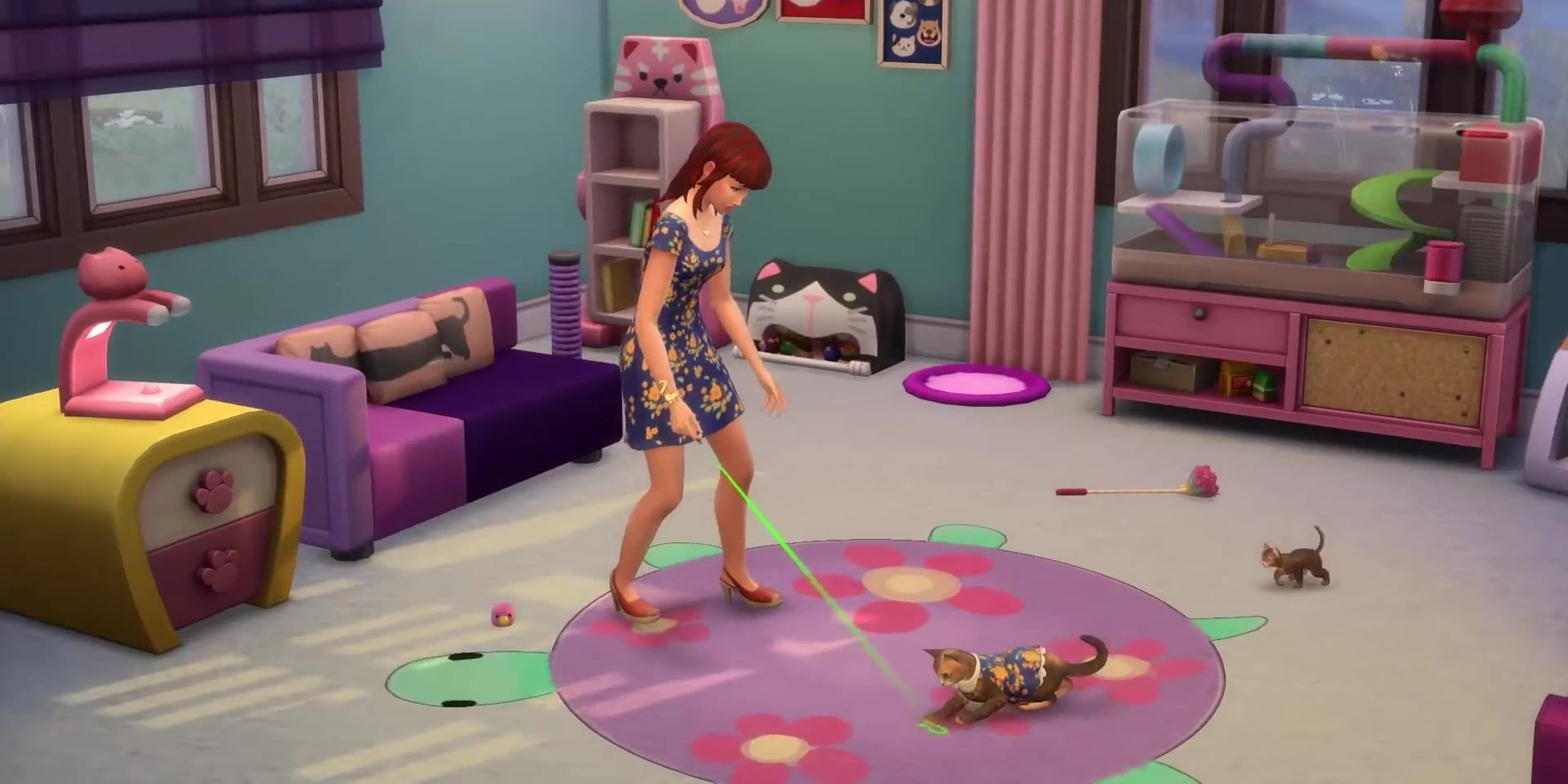 A Sim plays with her cat while kittens run around the brightly-colored purple and blue room