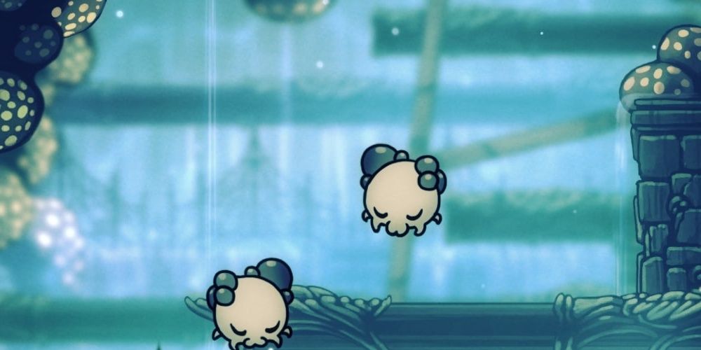 Two Funglings floating in the air in Hollow Knight.