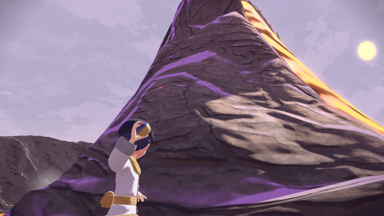 Pokemon Trainer aiming his pokeball at Unown B in a volcano, in Pokemon Legends Arceus.