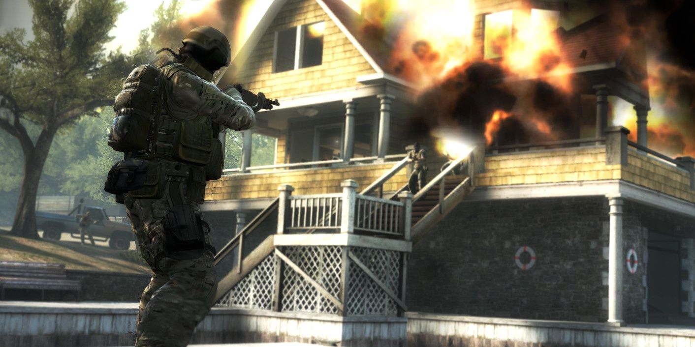 A screenshot showing a player taking aim in from of an exploding building in Counter-Strike:Global Offensive
