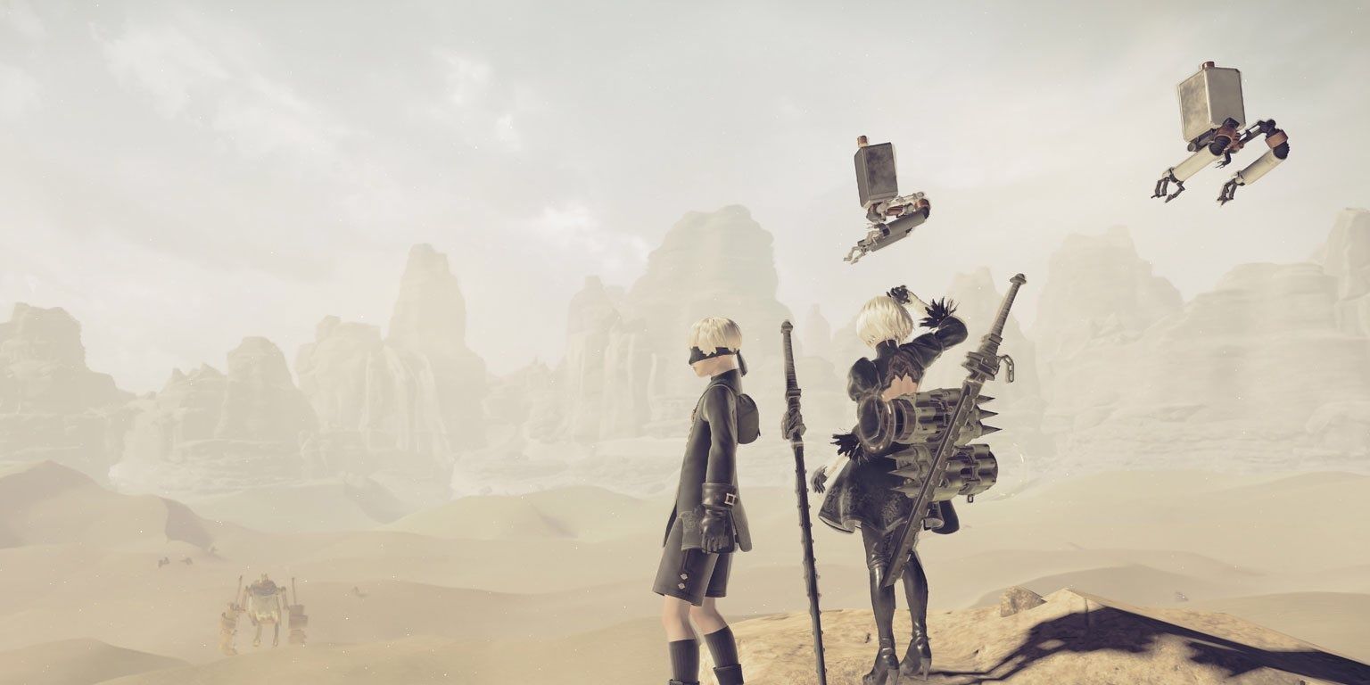 2B, 9S, and their Pods in the desert in Nier Automata