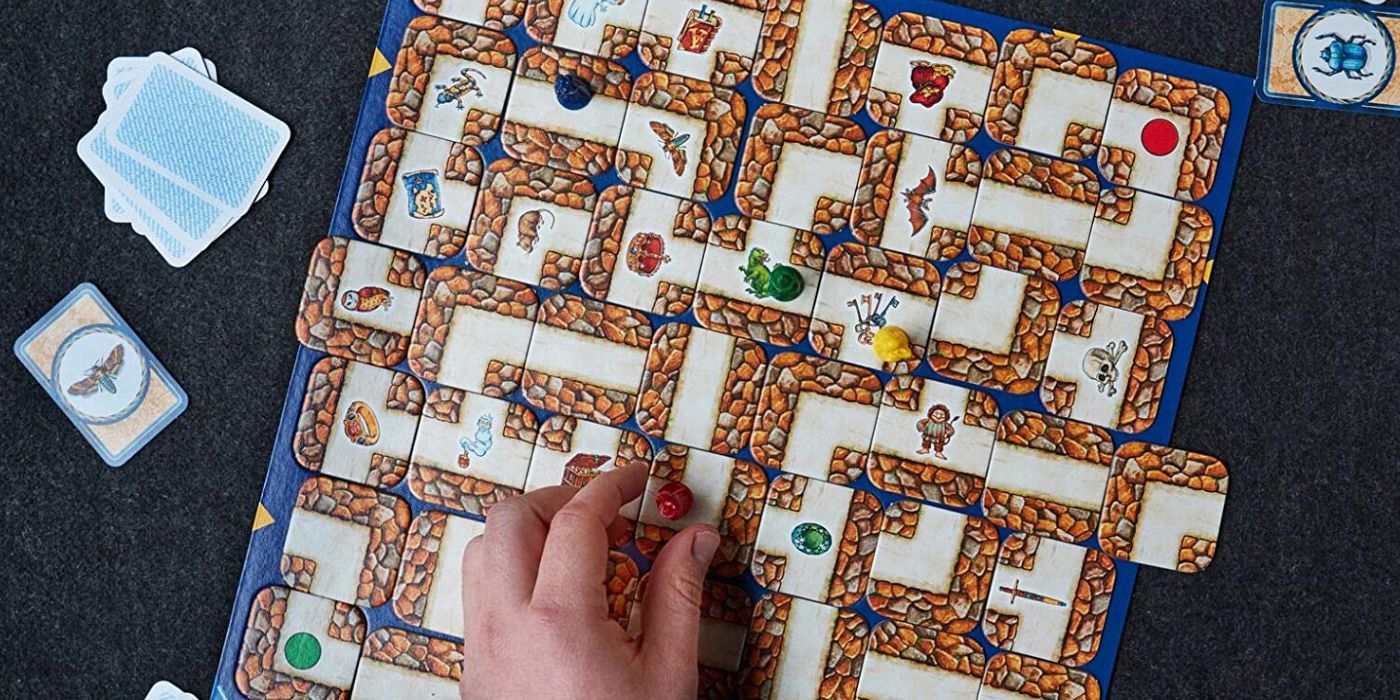 Labyrinth game tiles on a table with cards