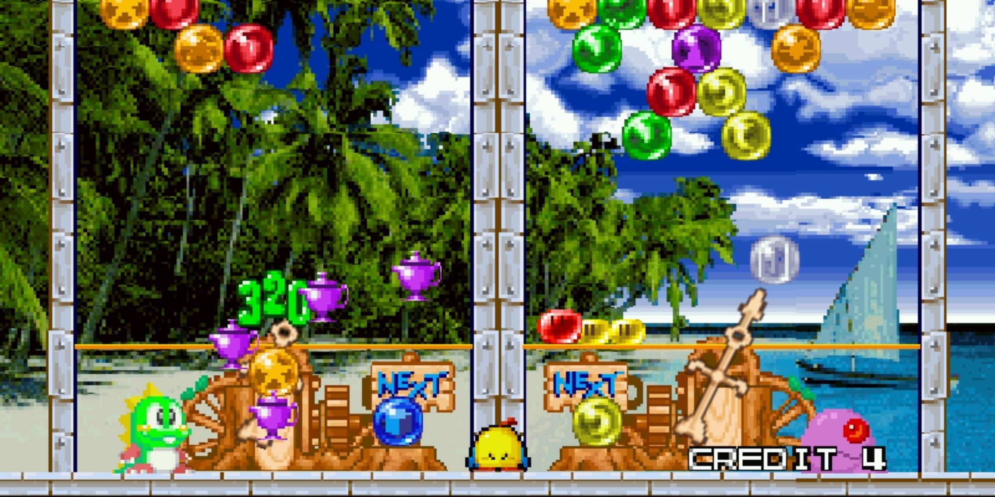 Puzzle Bobble 2 Arena Game against the computer. The game is set against a beach style background, Bub is the player character and Monsta is the computer.