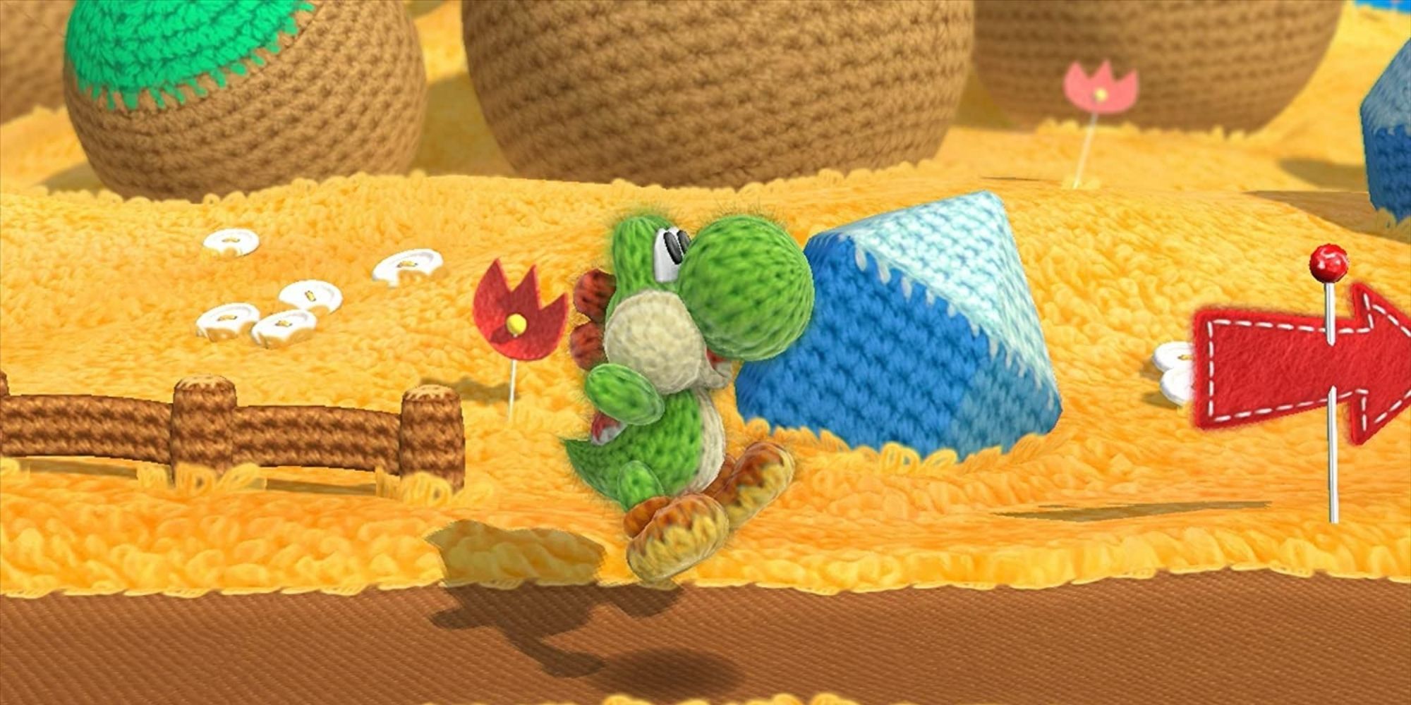 Knitted Yoshi from Yoshi's Woolly World, he is jumping in the air at the start of a level.