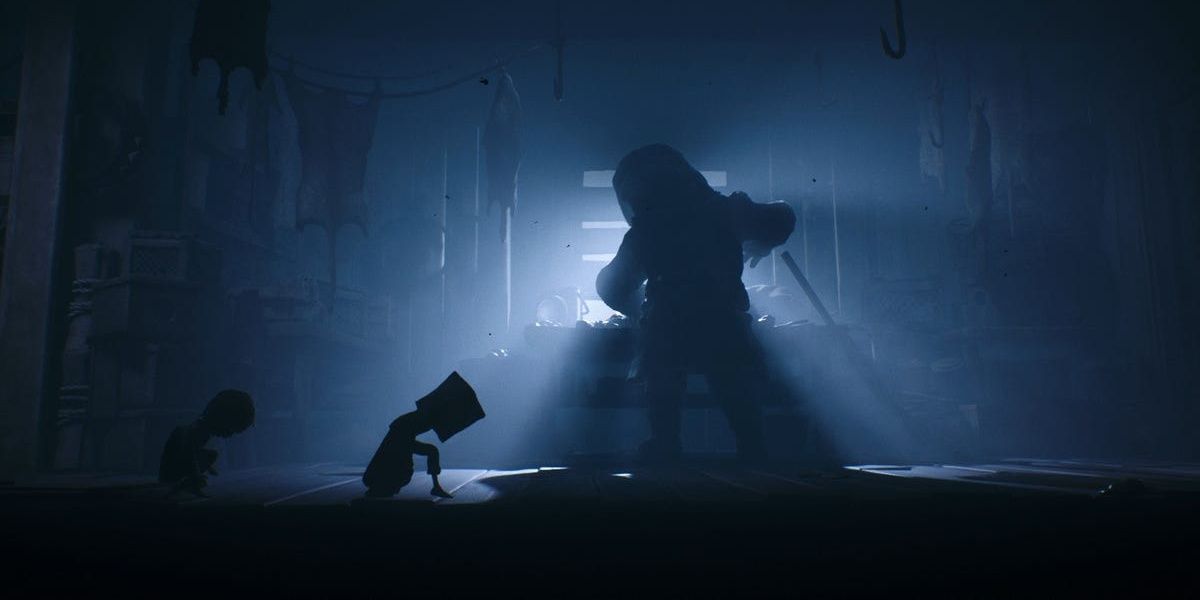 A screenshot showing Mono and Six sneaking past the Hunter in Little Nightmare 2