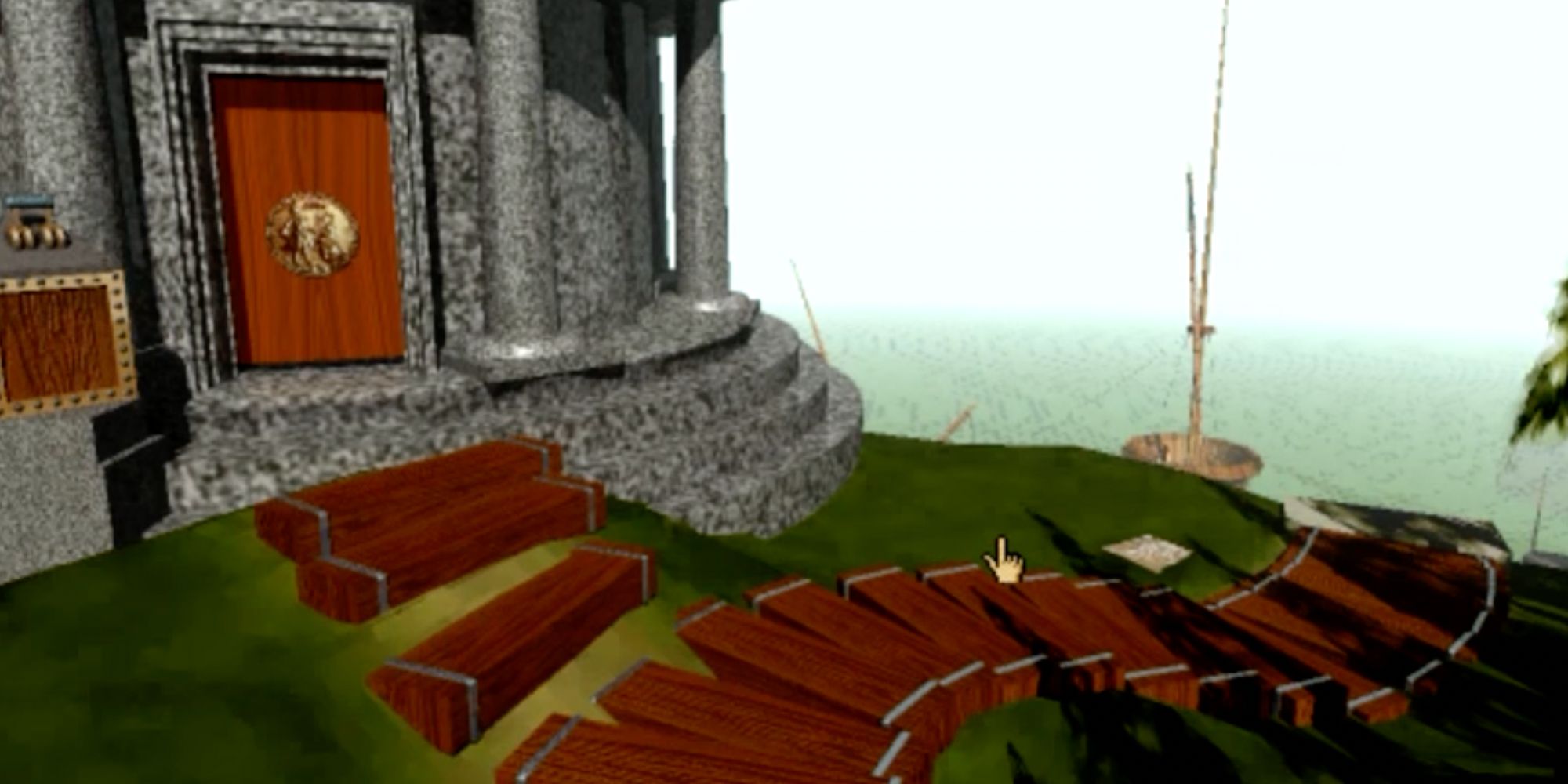A screenshot from the original Myst, showing a stone building next to a set of stairs that leads to a foggy harbor