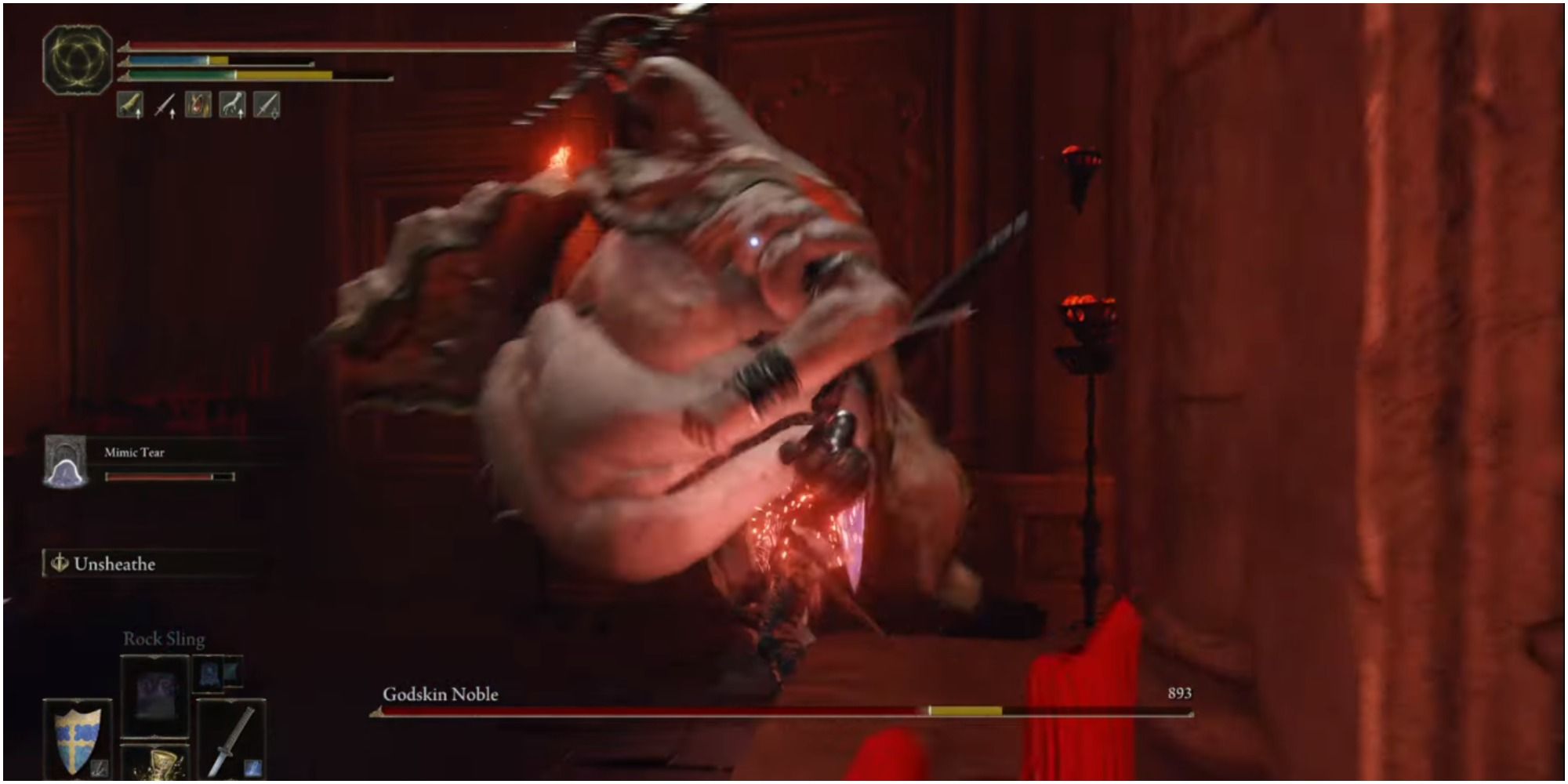 Tarnished attacking the boss with a melee weapon.