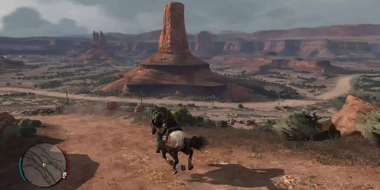 A screenshot showing John Marsten riding into Mexico in Red Dead Redemption