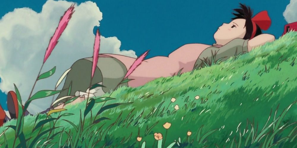 A screenshot of Kiki laying in the grass.