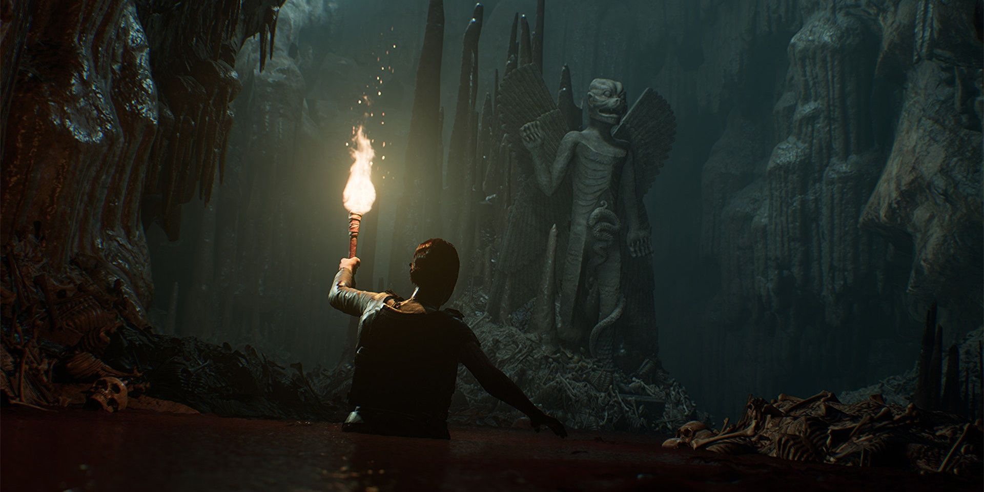A character holds a torch to illuminate a cave in House of Ashes