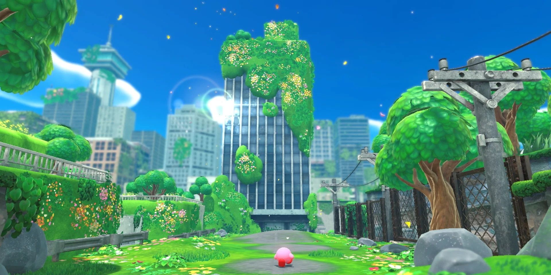 Kirby stands in front of a plant-covered building with a powerline to his right