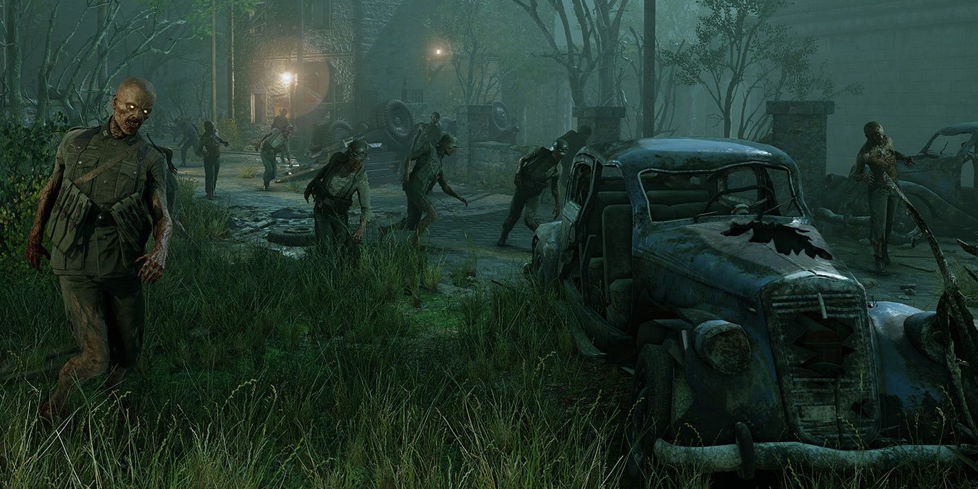 Zombies shamble through a town at night in Zombie Army 4 Dead War