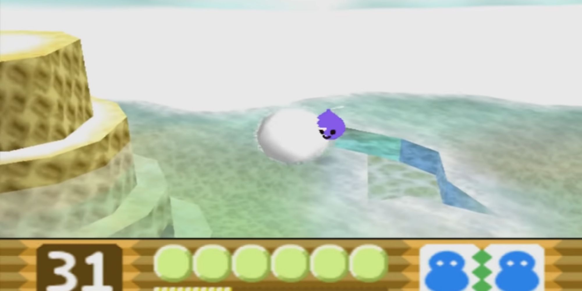 Kirby as a Snowball absorbs enemies while rolling across the ice