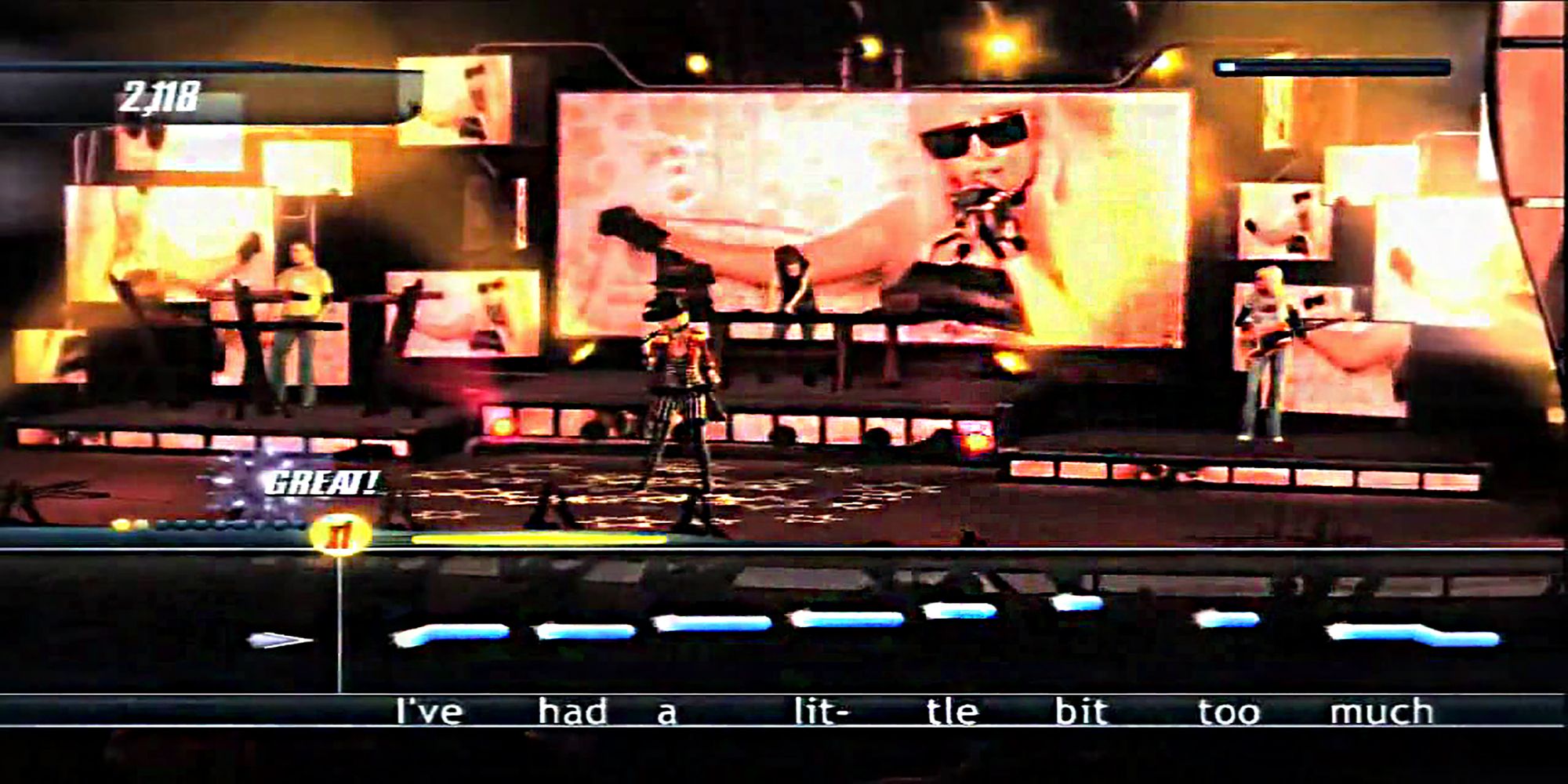 A top-hat adorned superstar sings on a concert stage with Lady Gaga's Poker Face music video in the background in Karaoke Revolution Wii.