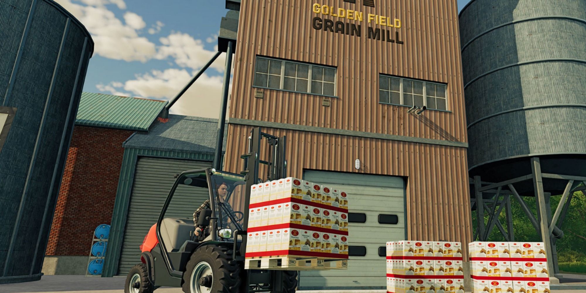 a farm worker loading items near a grain mill in farming simulator 22