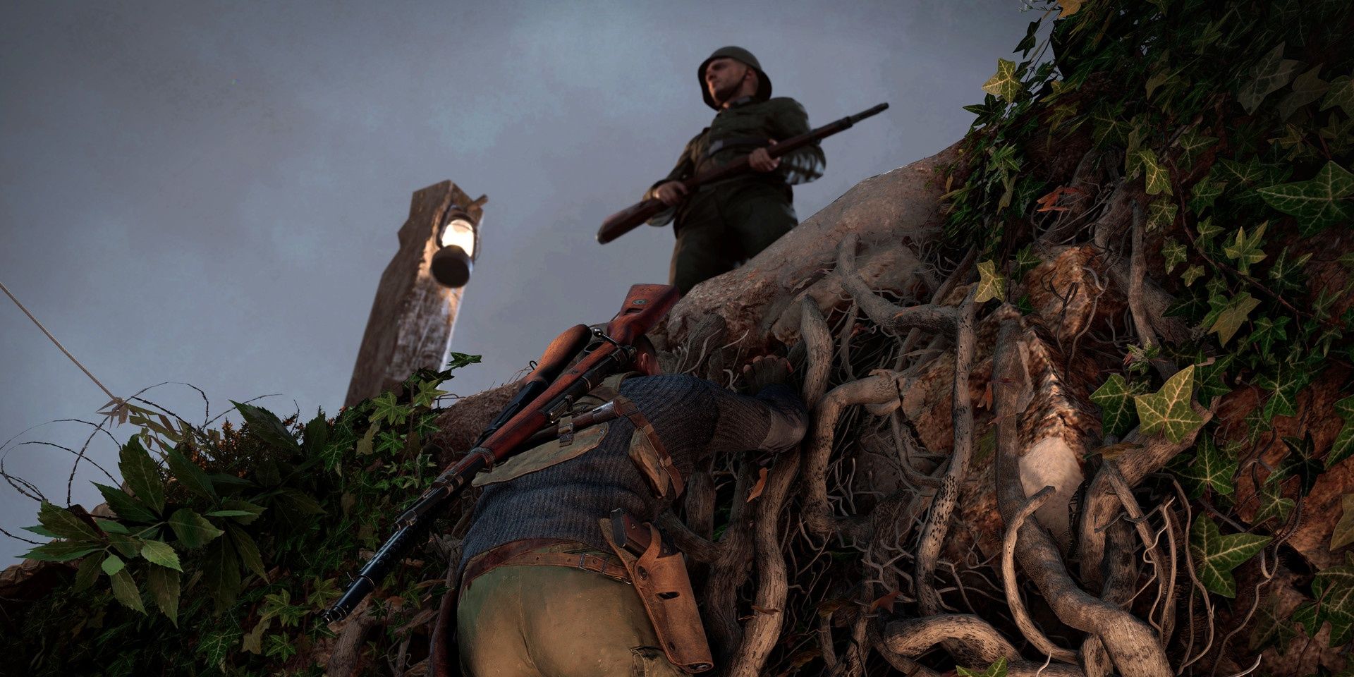 A screenshot showing Karl hanging from a ledge directly beneath an enemy soldier in Sniper Elite 5