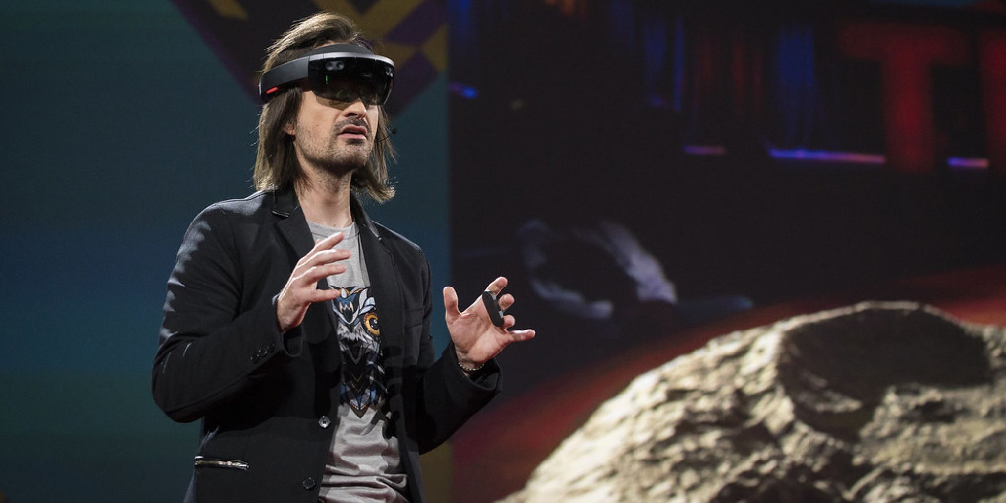 Alex Kipman wearing a hololense on stage