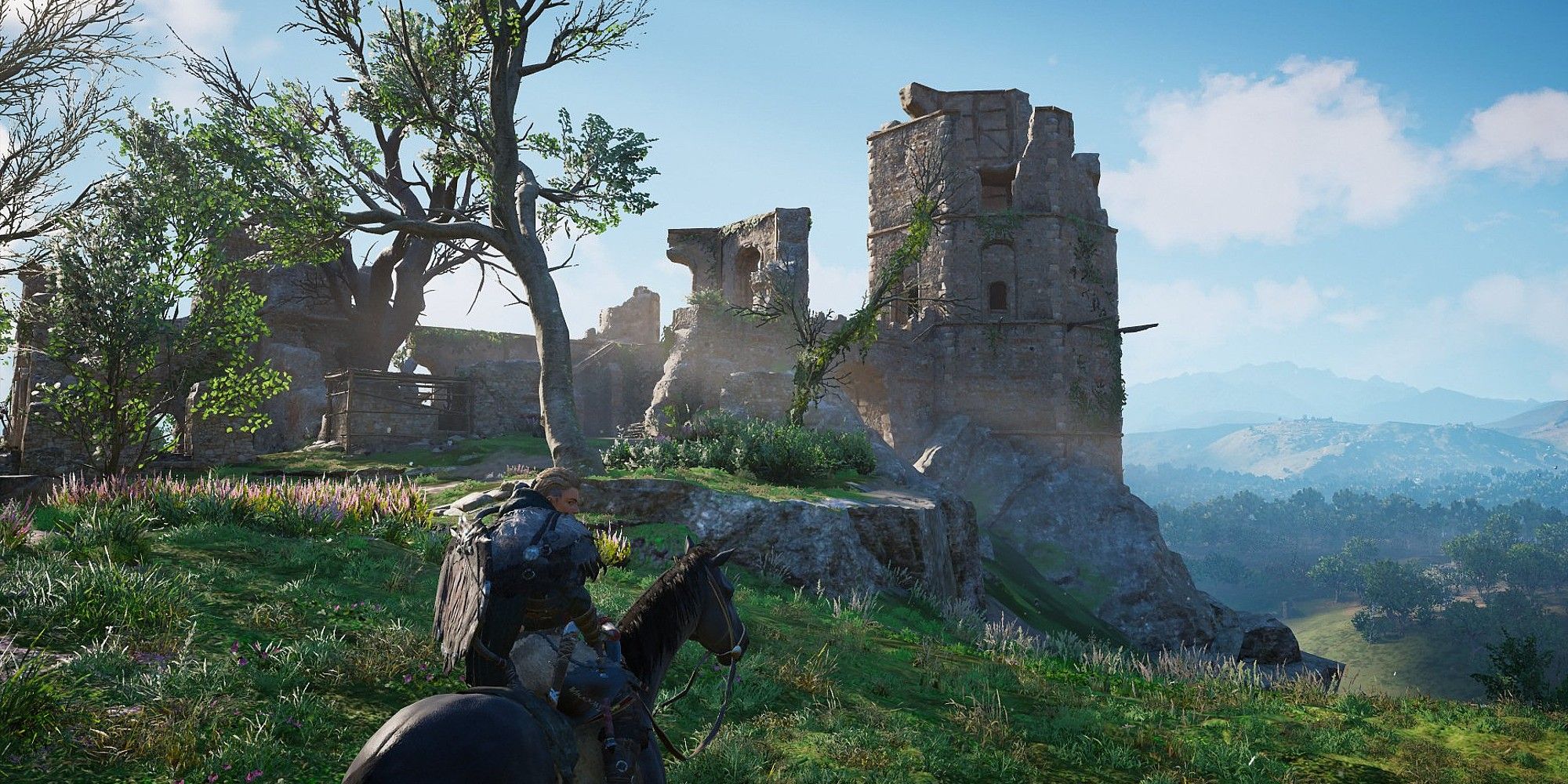 Eivor is on horseback, outside the ruins of a castle on a hill