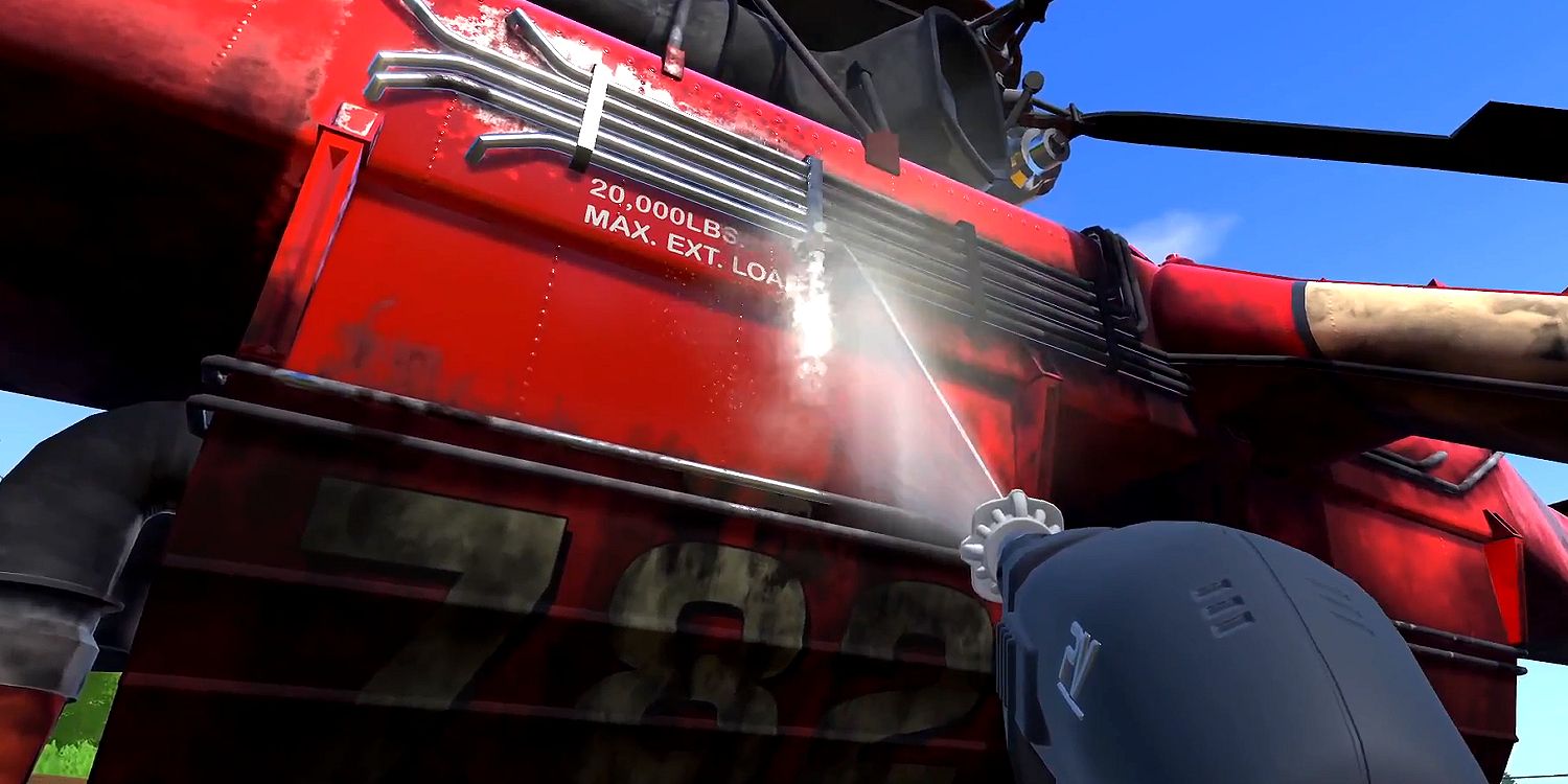 Cleaning a red helicopter with a pressure washer